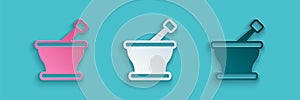 Paper cut Mortar and pestle icon isolated on blue background. Paper art style. Vector photo