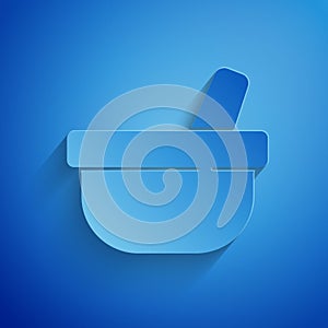 Paper cut Mortar and pestle icon isolated on blue background. Paper art style. Vector photo