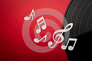 Paper cut of music note on Black vinyl record lp album disc with copy space for text