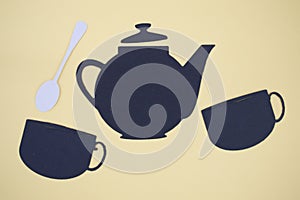 Paper cut out of tea pot, cups, and spoon
