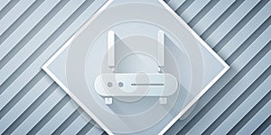 Paper cut Router and wi-fi signal icon isolated on grey background. Wireless ethernet modem router. Computer technology