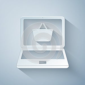 Paper cut Shopping basket on screen laptop icon isolated on grey background. Concept e-commerce, e-business, online