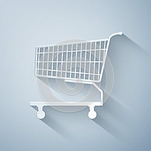 Paper cut Shopping cart icon isolated on grey background. Online buying concept. Delivery service sign. Supermarket