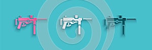 Paper cut Submachine gun M3, Grease gun icon isolated on blue background. Paper art style. Vector