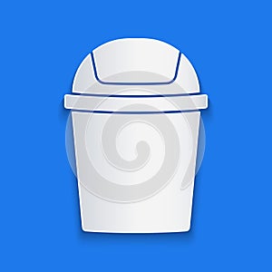 Paper cut Trash can icon isolated on blue background. Garbage bin sign. Recycle basket icon. Office trash icon. Paper