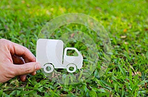 Paper cut of truck on green grass background