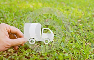 Paper cut of truck on green grass background