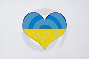 Paper cut Ukraine flag in the shape of the heart