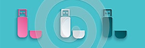 Paper cut USB flash drive icon isolated on blue background. Paper art style. Vector Illustration