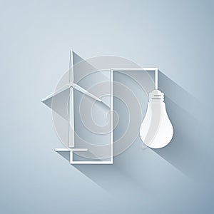 Paper cut Wind mill turbine generating power energy and light bulb icon on grey background. Alternative natural