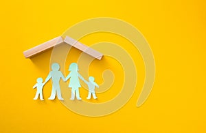 Paper cutout of family (father, mother, son and daughter). Life insurance concept