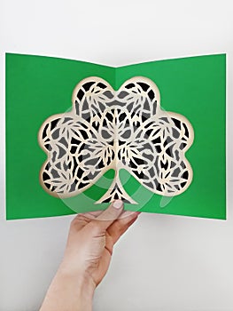 Paper cutting of green clover shamrock process, made by hand.