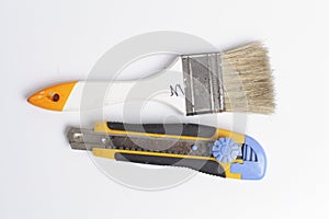 Paper cutting knife and clean paint brush isolated on white background