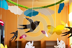 Paper decor of butterflies and birds hanging