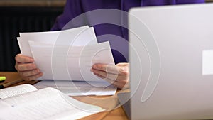 paper documents working female businessman holding papers hands looking through