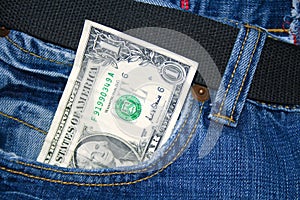 Paper dollar in a jeans pocket