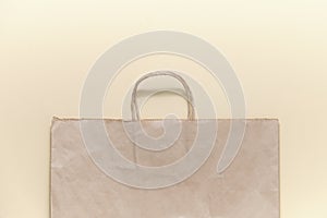 paper eco bag for shopping on a beige background