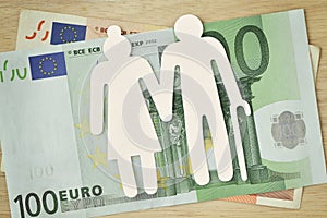 Paper elderly couple cut-out on euro banknotes - Pension concept photo