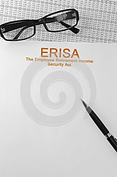 Paper with Employee Retirement Income Security Act ERISA on a table