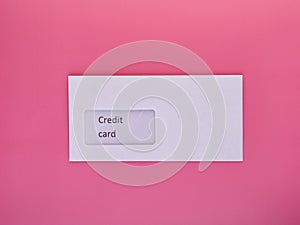 Paper envelope with credit card inside isolated on pink background, blank mockup