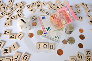 paper euro banknotes of european union, piggy bank, bills on table among euro coins, word money with wood blocks, cash payments,