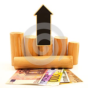 Paper euro money and wooden logs