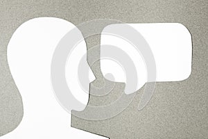 Paper face and speech bubble on colorbackground copy space for text, communication, symbolic- Image