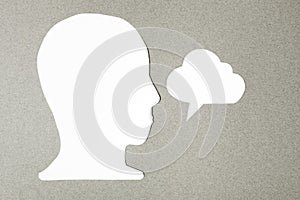 Paper face and speech bubble on colorbackground copy space for text, communication, symbolic- Image