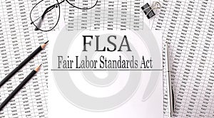 Paper with Fair Labor Standarts Act FLSA on a table