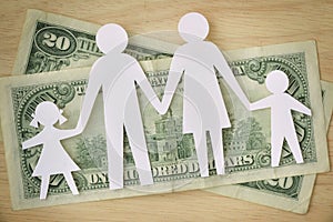 Paper family cut-out on dollars banknotes - Family budget concept