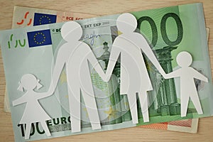 Paper family cut-out on euro banknotes - Family budget concept