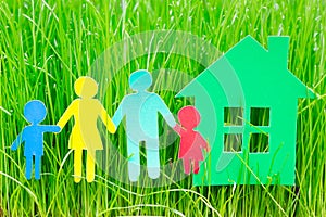 Paper family and house in grass