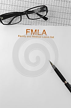 Paper with Family Medical Leave Act FMLA on a table