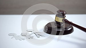 Paper family sign on table, gavel standing on sound block, divorce proceeding