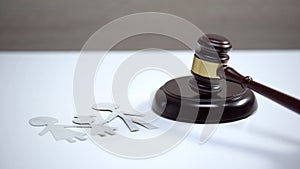 Paper family sign on table, gavel standing on sound block, divorce proceeding photo