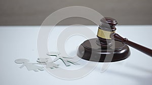 Paper family sign on table, gavel striking on sound block, divorce proceeding