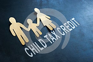 Paper family and words child tax credit on blackboard.