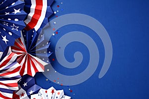 Paper fans in color of American flag and confetti on dark blue background. USA Labor Day, Independence Day, Columbus Day banner
