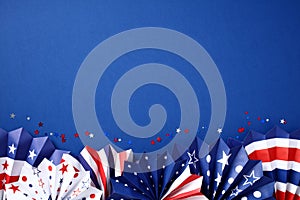 Paper fans in color of American flag on dark blue background. Happy American Independence Day, USA Labor day, Presidents Day