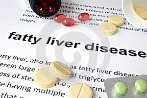 Paper with fatty liver disease and pills.