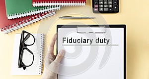 Paper with Fiduciary duty on a table