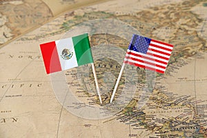 The United States of America and Mexico flag pins on a world map, political relations concept