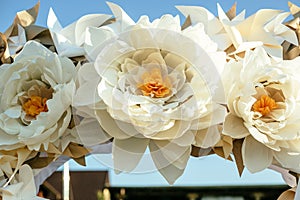 Paper flowers in wedding decor, luxury wedding decorations for ceremony. Wedding arch