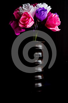 Paper flowers in wooden vase