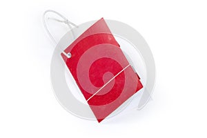 Paper folded clothing swing tag on rope on white background