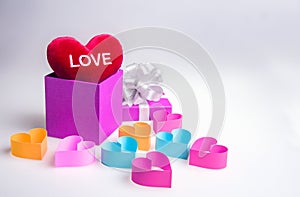 Paper gift box and hearts on white background