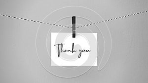 Paper hanging on a rope with a brooch with the phrase thank you. Inspirational quote.  Thank you card, banner, poster or design.