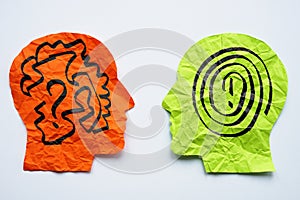 Paper heads with drawn lines as a concept for mentoring, teaching and psychotherapy.