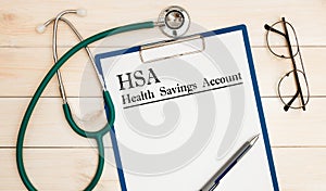 Paper with Health Savings Account HSA on a table