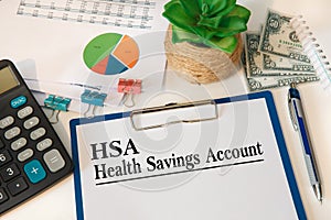 Paper with Health Savings Account HSA on a table